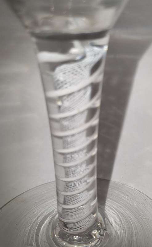 18th Century English engraved bowl glass with air-twist stem and white twist stem.