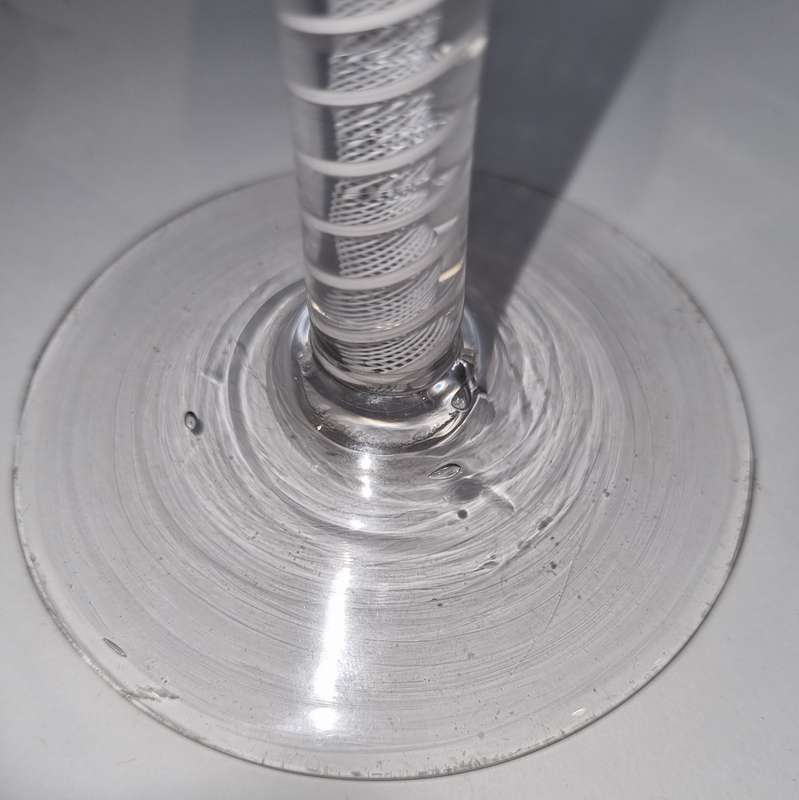 18th Century English engraved bowl glass with air-twist stem and white twist stem.