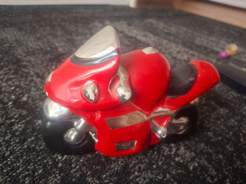 Red piggy bank motorbike