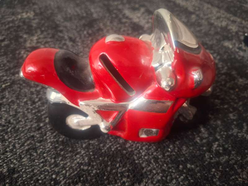 Red piggy bank motorbike