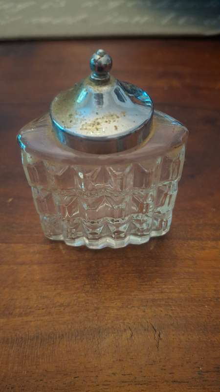 Glass bottle with metal top
