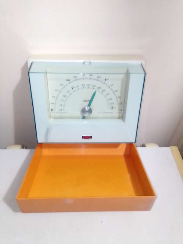 Orange and White Krups fold away wall hanging scale 1.5 to 3kg.