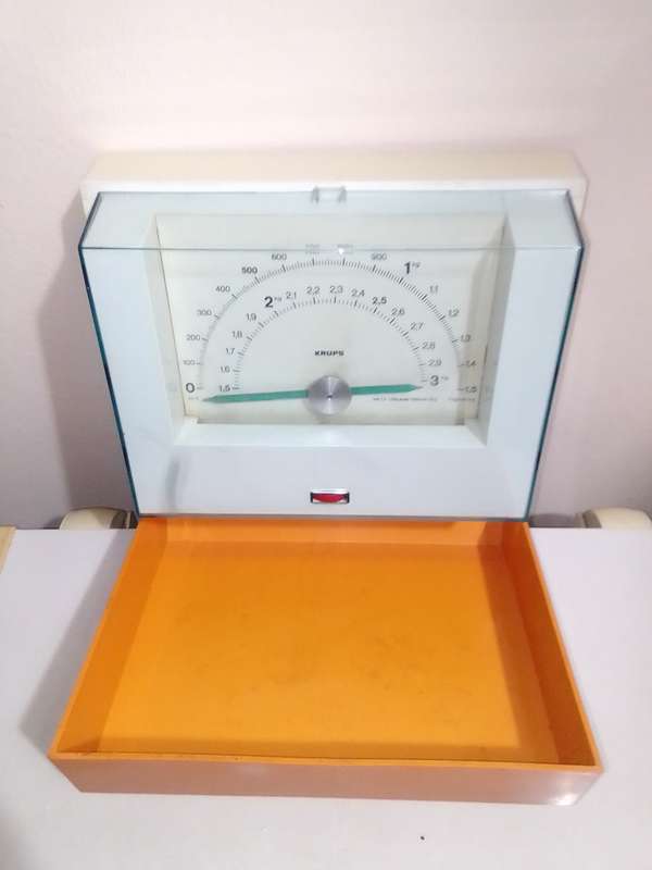Orange and White Krups fold away wall hanging scale 1.5 to 3kg.