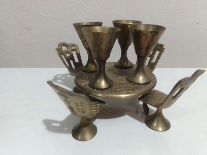 Handcrafted miniature bras dining table set that includes a table and four chairs and 4 goblets.