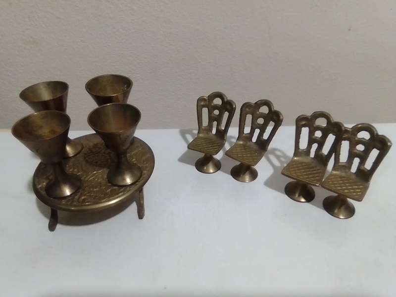 Handcrafted miniature bras dining table set that includes a table and four chairs and 4 goblets.