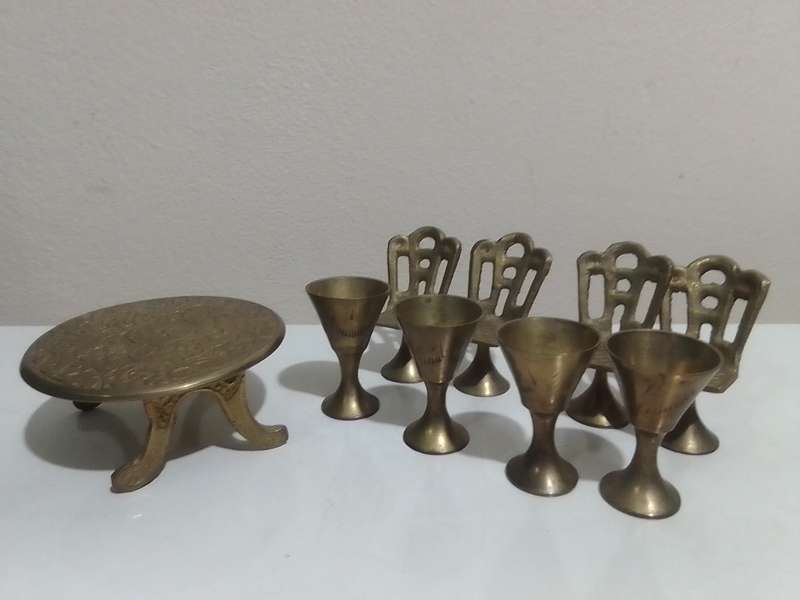 Handcrafted miniature bras dining table set that includes a table and four chairs and 4 goblets.