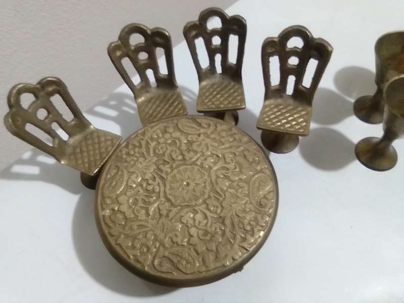 Handcrafted miniature bras dining table set that includes a table and four chairs and 4 goblets.