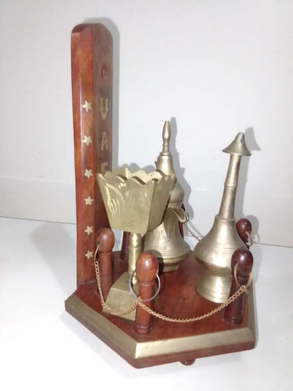 Wow a collection of Incense burners on wooden stand.
