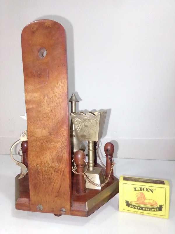 Wow a collection of Incense burners on wooden stand.
