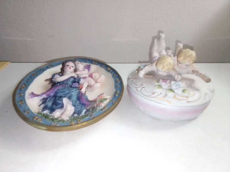 A Damsel and cherub Porcelain/polyresin wall plaque and a Cherub trinket lidded box.