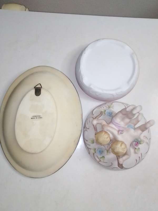 A Damsel and cherub Porcelain/polyresin wall plaque and a Cherub trinket lidded box.