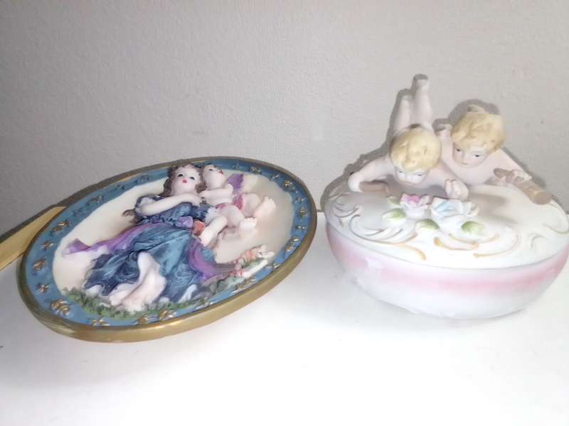 A Damsel and cherub Porcelain/polyresin wall plaque and a Cherub trinket lidded box.