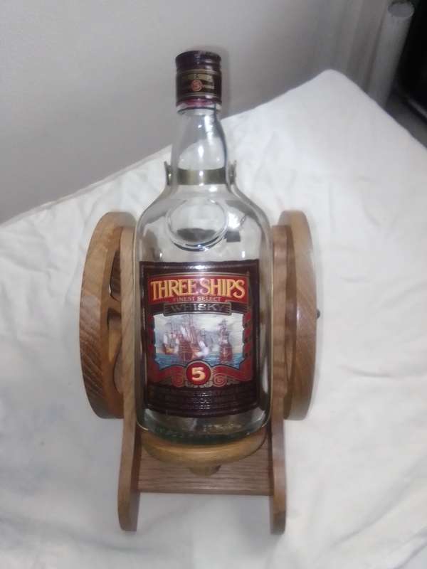 Vintage empty Three Ships 5 year old Scotch whisky  on Cannon framework.
