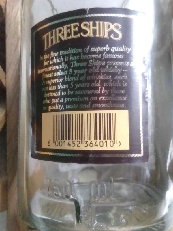 Vintage empty Three Ships 5 year old Scotch whisky  on Cannon framework.