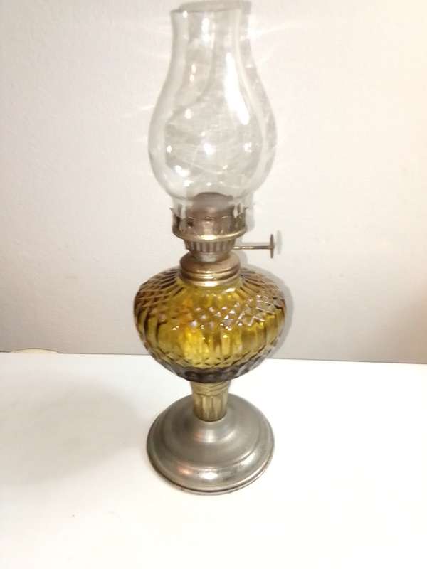 A small/mini Amber decorative paraffin/kerosene oil lamp.