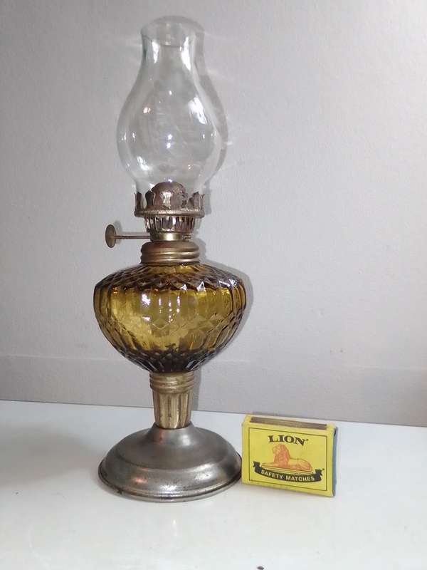 A small/mini Amber decorative paraffin/kerosene oil lamp.