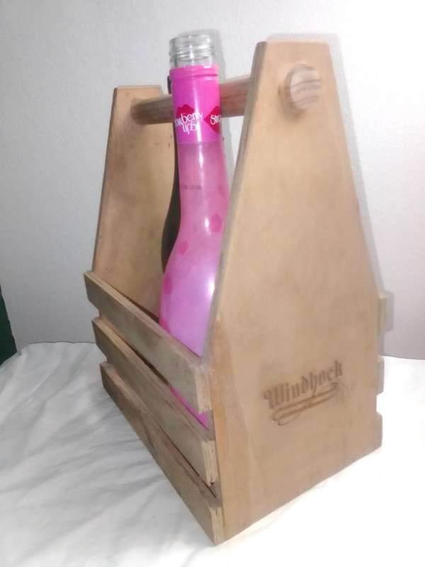 A Windhoek Beer wood Caddy/Carrier and with bottle opener.