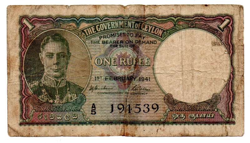 1941 Ceylon 1 Rupee Pick#34 edge tears and folds with 2 spike holes