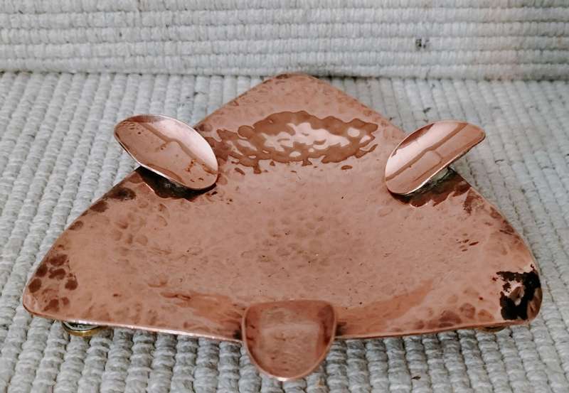 A Magnificent Mid Century Hammered Copper Ashtray with Feet