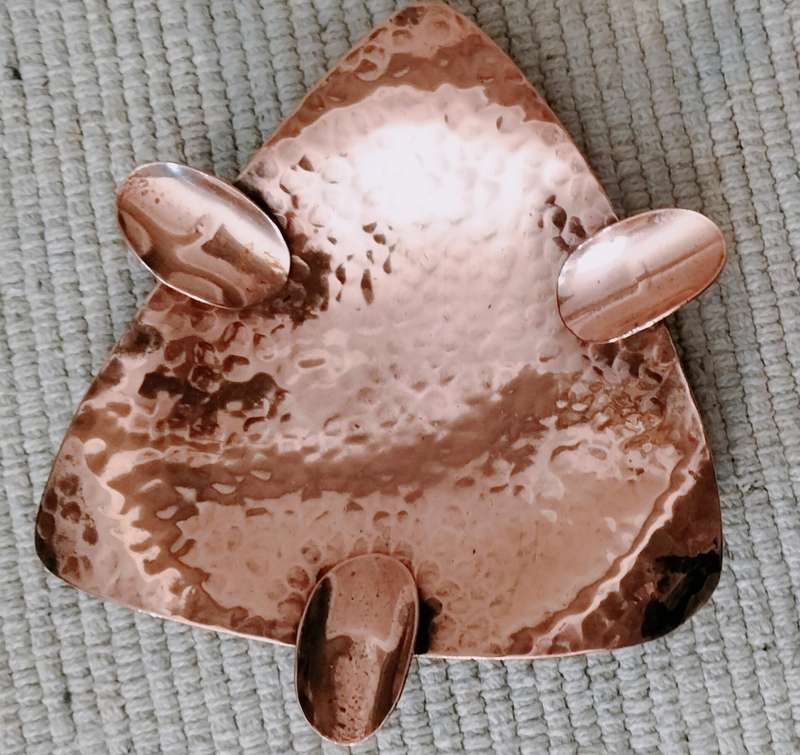 A Magnificent Mid Century Hammered Copper Ashtray with Feet