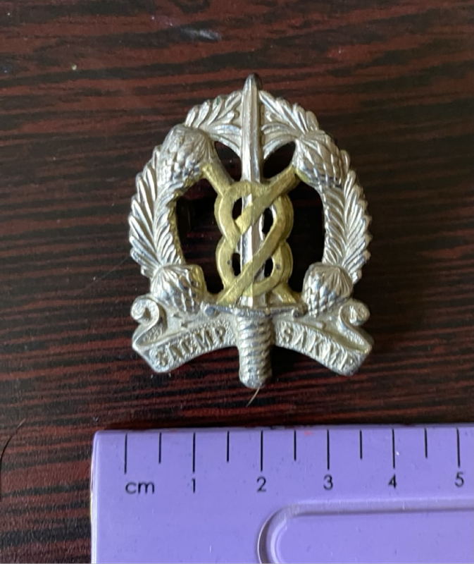 Cap badge of the South African Corps of Military Police (SACMP)