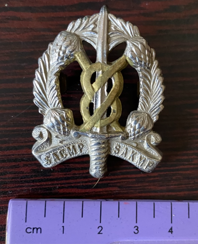 Cap badge of the South African Corps of Military Police (SACMP)
