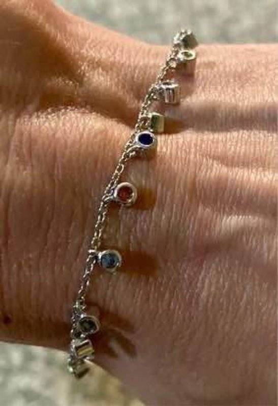 Delicate 19cm long gemstone charm tennis bracelet. 14 semi precious stones (varied)