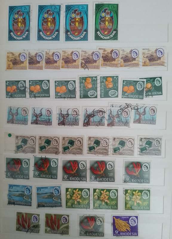 MIXED ALBUM STAMPS.RSA.RHODESIAS.BOTSWANA.AUSTRALIA.USA AND MORE SEE SCANS
