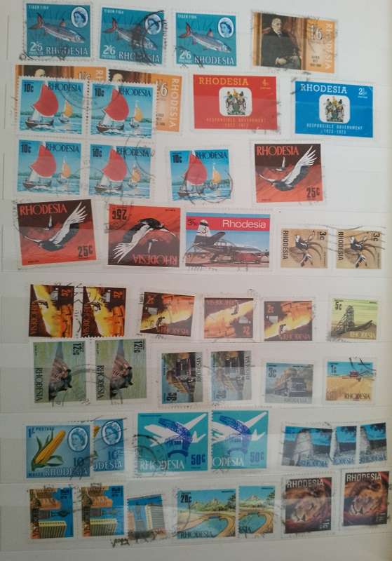 MIXED ALBUM STAMPS.RSA.RHODESIAS.BOTSWANA.AUSTRALIA.USA AND MORE SEE SCANS