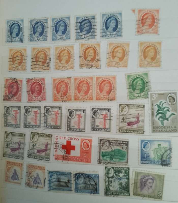 MIXED ALBUM STAMPS.RSA.RHODESIAS.BOTSWANA.AUSTRALIA.USA AND MORE SEE SCANS