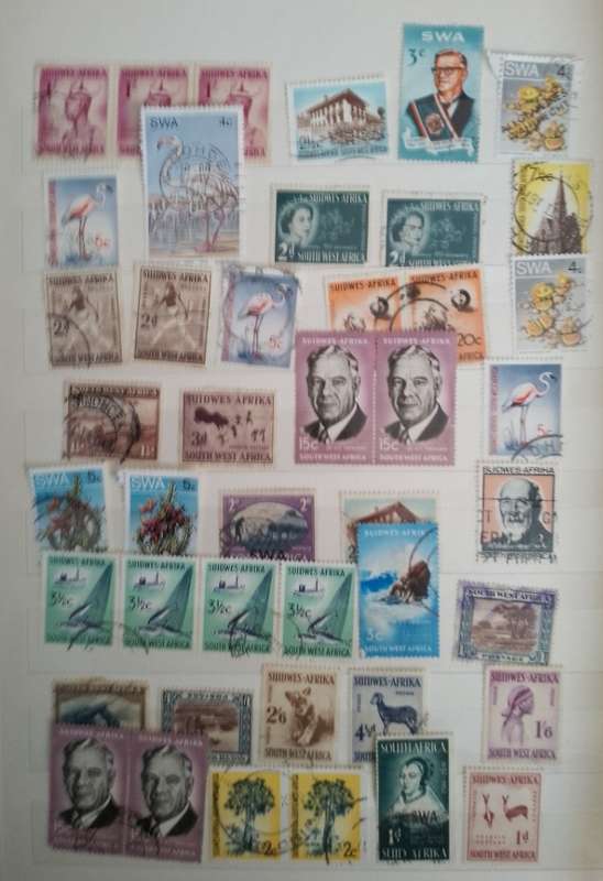 MIXED ALBUM STAMPS.RSA.RHODESIAS.BOTSWANA.AUSTRALIA.USA AND MORE SEE SCANS