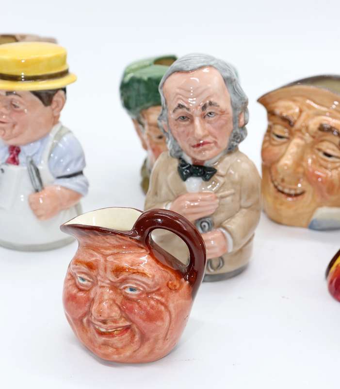 Collection of Royal Doulton character jugs , ashtrays and candle snufflers