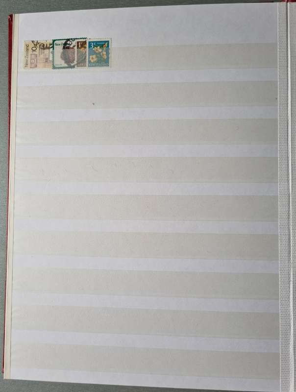 RED ALBUM 2ND HAND WITH MIXED WORLD STAMPS (MOSTLY USED). AS PER IMAGES. NB: PLEASE READ BELOW!!