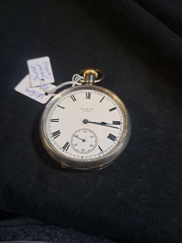 Silver Elgin pocket watch (no glass and runs and stops,back does not close)