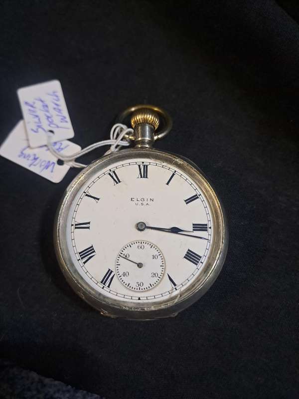 Silver Elgin pocket watch (no glass and runs and stops,back does not close)