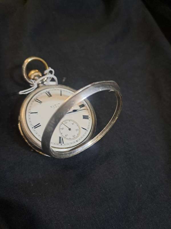 Silver Elgin pocket watch (no glass and runs and stops,back does not close)
