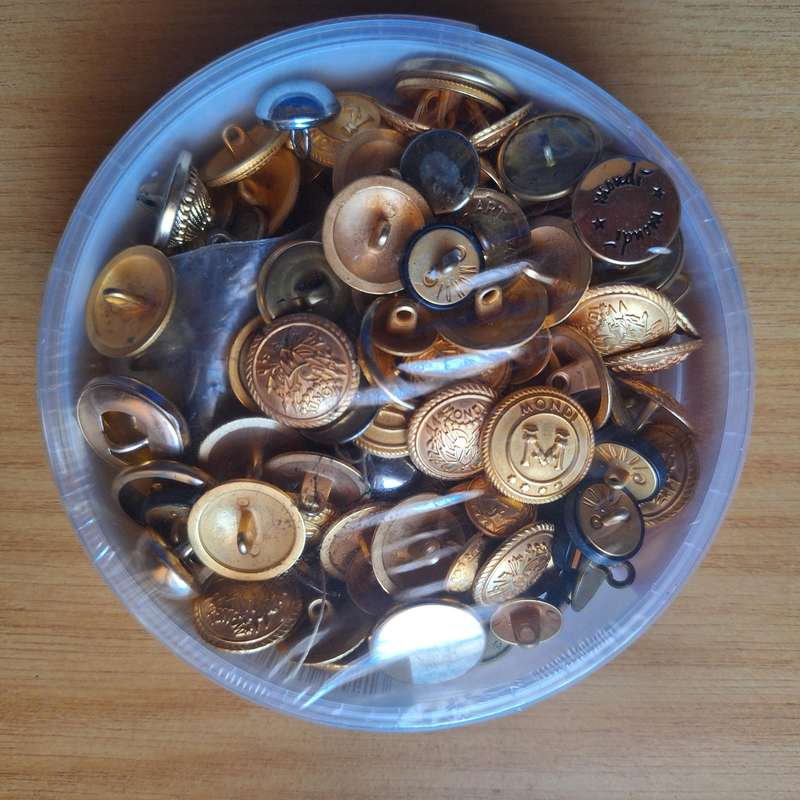 Bucket full of vintage steel buttons