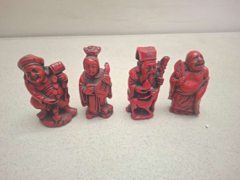 Four small red oriental red figurines