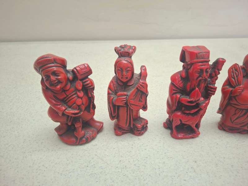 Four small red oriental red figurines