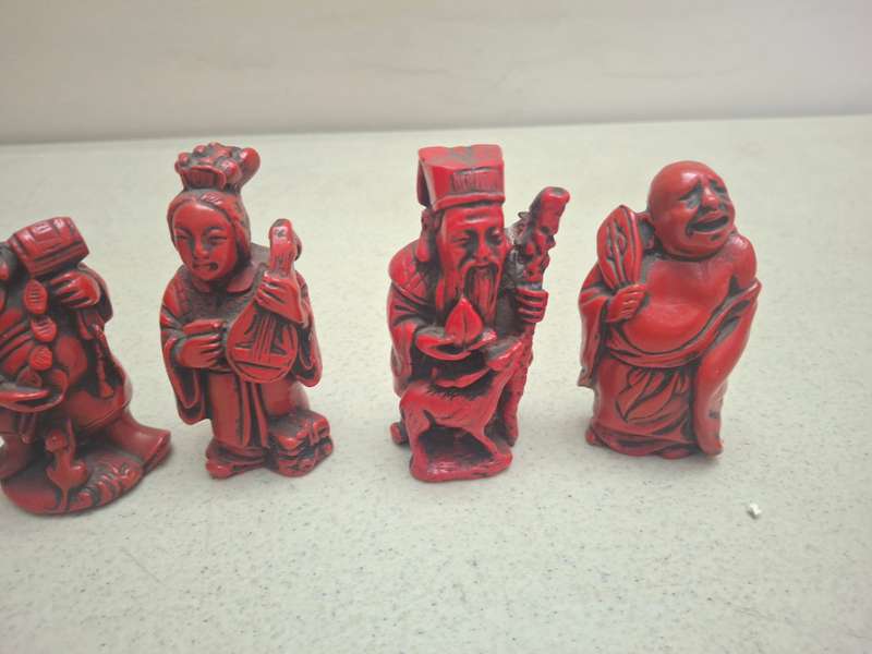 Four small red oriental red figurines