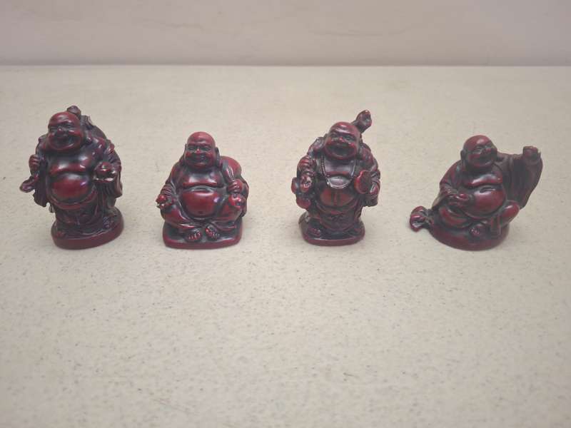A lot of four small resin buddha figurines