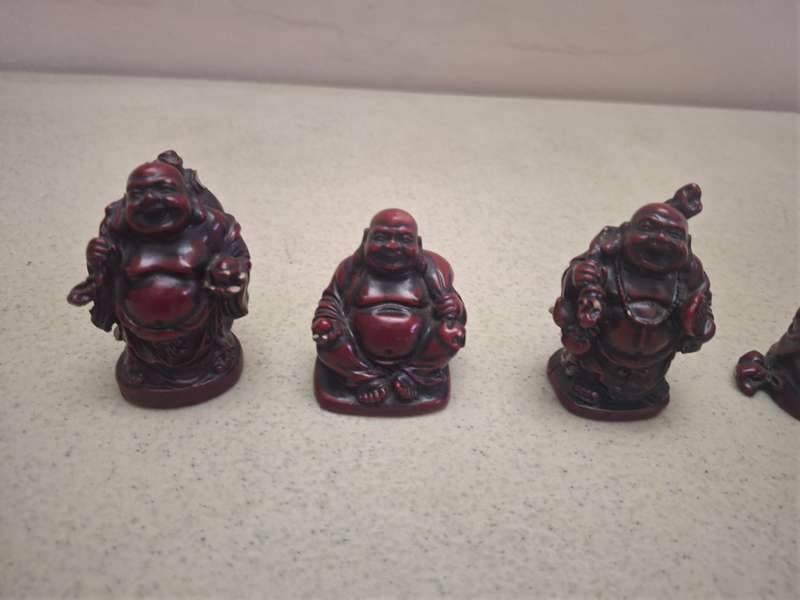 A lot of four small resin buddha figurines