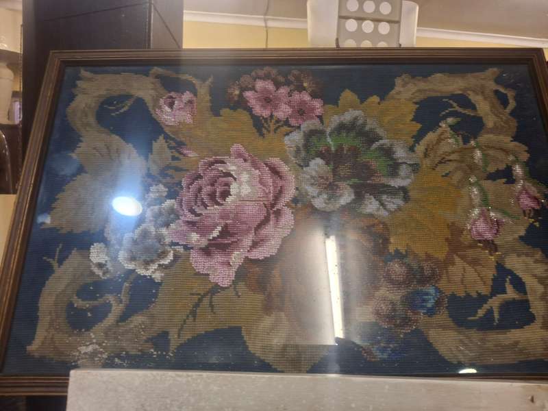 Stunning beaded rose taperstry behind glass