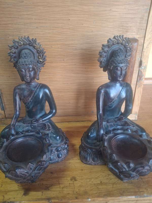 A pair of oriental resin made buddha candle holders