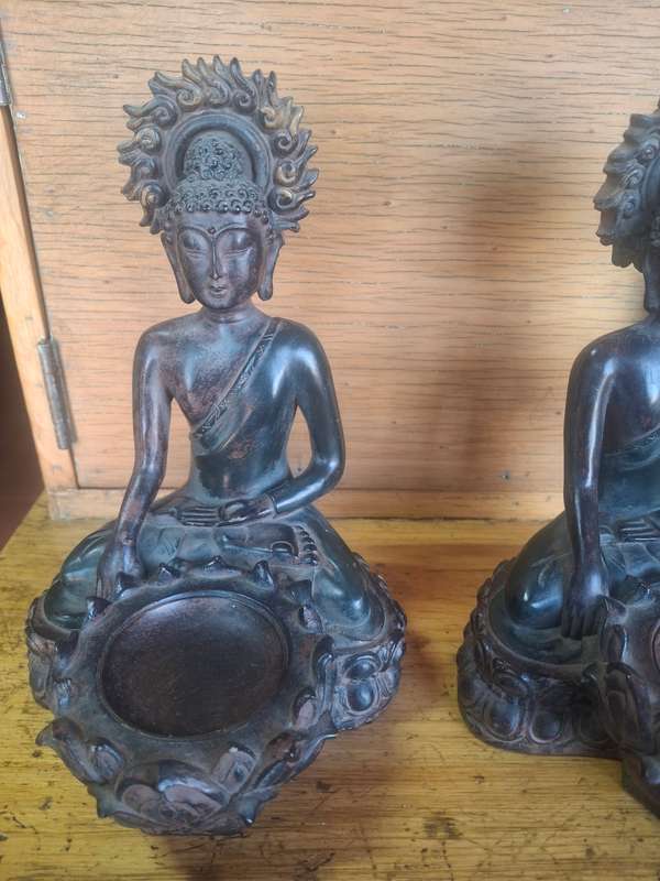 A pair of oriental resin made buddha candle holders