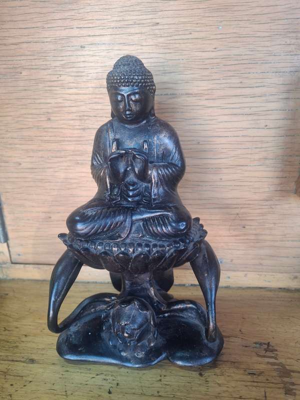 Interesting buddha sitting on a flower