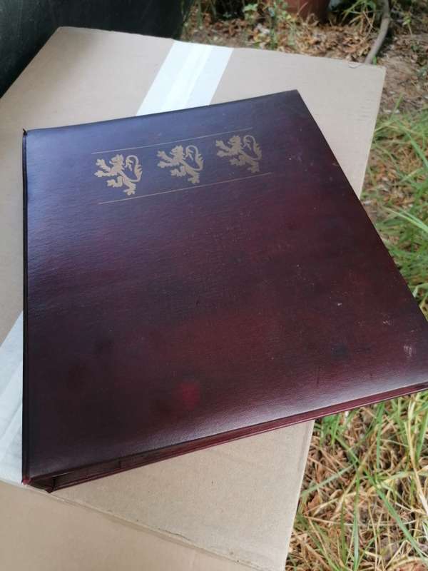 A BOOK of 22k Gold postage stamps, "The Royal Coats of Arms of the Kings and Queens of England", ple