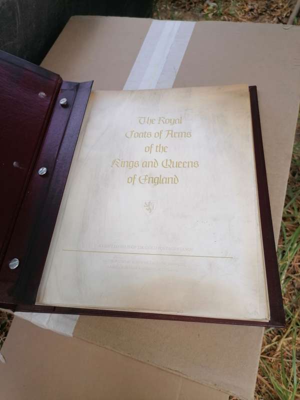 A BOOK of 22k Gold postage stamps, "The Royal Coats of Arms of the Kings and Queens of England", ple