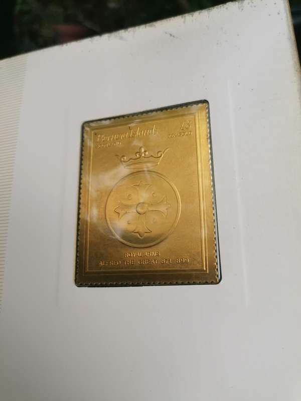 A BOOK of 22k Gold postage stamps, "The Royal Coats of Arms of the Kings and Queens of England", ple