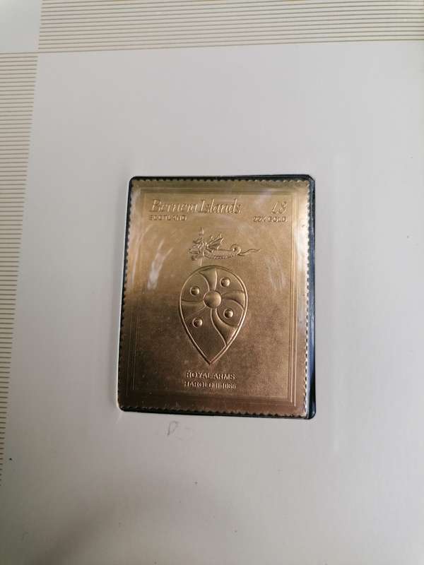 A BOOK of 22k Gold postage stamps, "The Royal Coats of Arms of the Kings and Queens of England", ple
